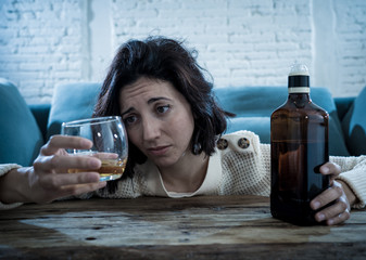 Young, sad, unhappy, helpless woman drinking alcohol. Human emotions, alcoholism and addictions