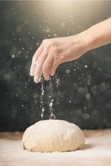 Woman's hands knead the dough close up