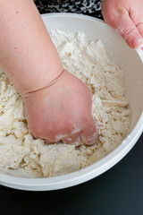 Mixing in a bowl of ingredients butter, cottage cheese and flour for the preparation of cookies