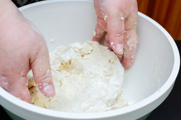 Mixing in a bowl of dough for the preparation of cottage cheese cookies