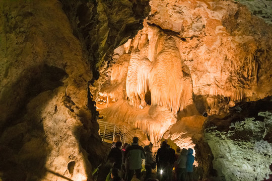 LEVIGLIANI, ITALY - JUNE 05, 2016: Some visitors admire the stalactites of the Antro del Monte Corchia cave in the Apuan Alps in Italy.
