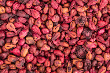 Closeup view of many dried red grapes filling the frame.