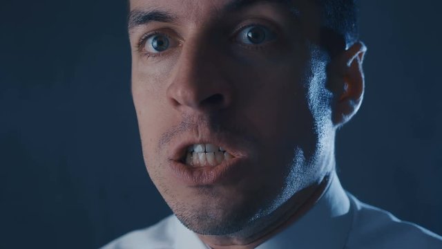 Close-up of angry businessman screaming, showing fear, rage and frustration.