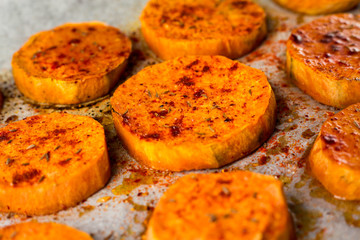 Baked sweet potato with garlic and rosemary. Paleo diet. Lunch. Homemade. Spices. Spicy.