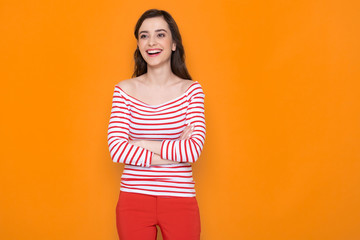 Obraz premium Waist up of happy brunette lady posing for camera in studio