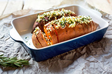 Baked sweet potato with garlic and rosemary. Paleo diet. Lunch. Homemade.