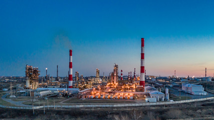 Russia. Ufa. April 2019. Башнефть Bashneft Flying above  chemical factory (refinery) in the late evening. Lights of night Ufa.