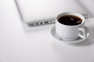 Laptop, notebook Tablet and cup of coffee on work desk