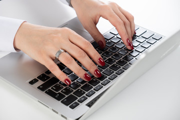 Fototapeta na wymiar Woman's hand typing on computer keyboard