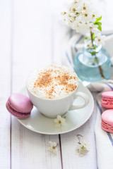 coffee and macaron in white wood background spring breakfast