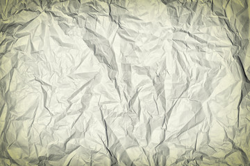 Crumpled gray paper. Blank background for layout with vignette. Paper texture closeup.