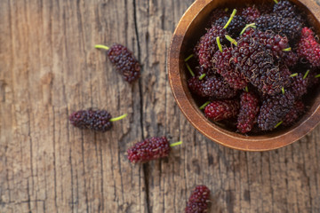 Fresh mulberry fruit on wood table background