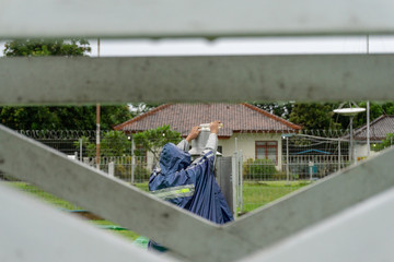 BALI/INDONESIA-DECEMBER 21 2017: A meteorological observer checks the Helman rain meter at...