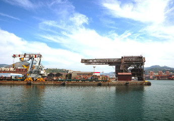Sea view of the industrial harbor of Genoa, Italy   with cranes and the structures of the containerport