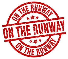 on the runway round red grunge stamp