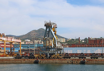Sea view of the industrial harbor of Genoa, Italy  with cranes and the structures of the...