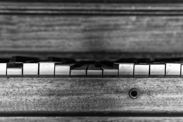 Old ruined piano keys in black and white