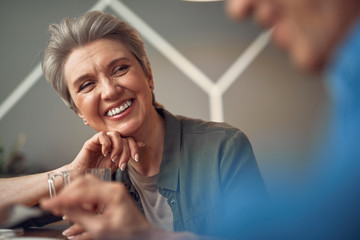 Happy smiling aged lady looking to her friend