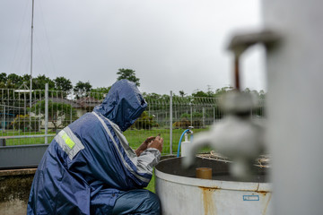 BALI/INDONESIA-DECEMBER 21 2017: A meteorological observer checks the water thermometer to make...