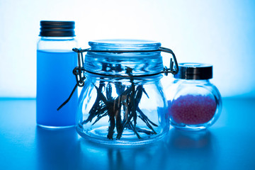 Glass jars on a blue background. Magical decoration