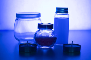 Glass jars on a blue background. Magical decoration