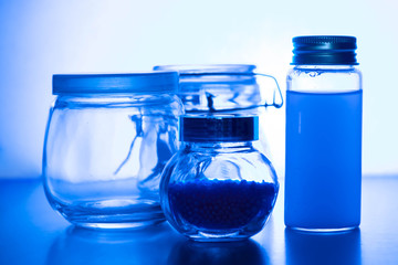 Glass jars on a blue background. Magical decoration