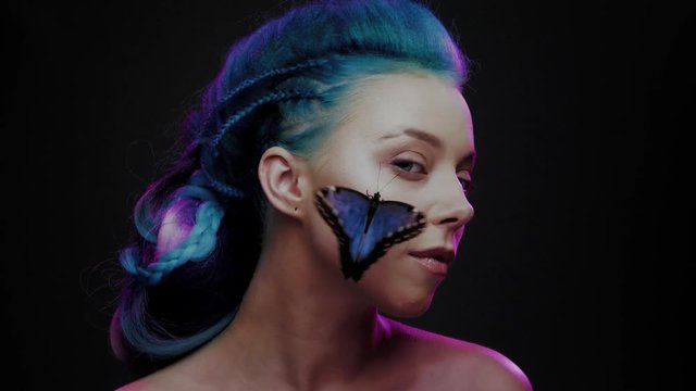 Beautiful woman with blue hair and butterfly