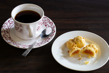 English tea in cup and fruits pie in plate on dark background
