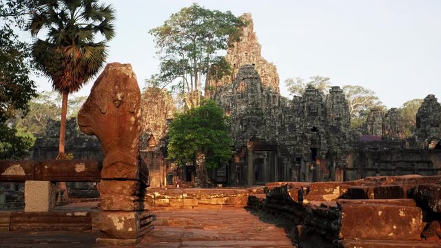 Sliding view of massive Bayon temple at sunrise. Built in 12-13th century it stands at the centre of Jayavarman's capital, Angkor Thom. Cambodia