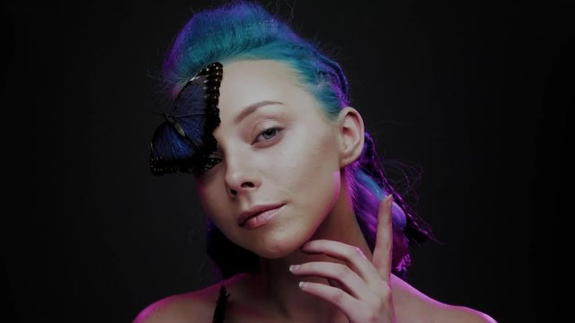 Beautiful woman with blue hair and butterfly