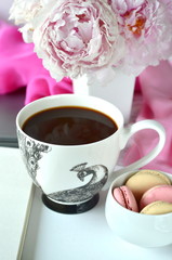 Elegant styled feminine desktop - relaxation, reading, creative writing, learning and journaling concept - with pink peonies, black coffee and stylish stationery