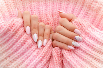 Female hands manicure close up view. Nail painting with marble effect. Drawing on nails