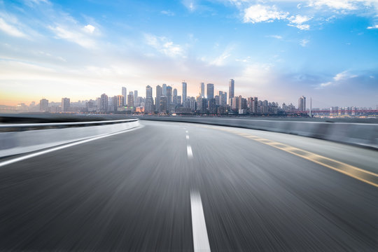 The Expressway And The Modern City Skyline Are In Chongqing, China.