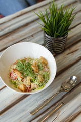 Caesar salad with souce on a table