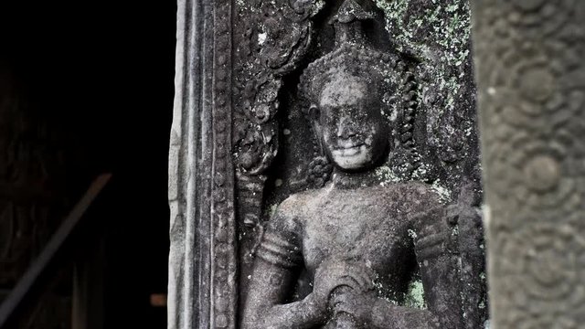 Close sliding view of amazing apsara bas-relief, a female spirit of the clouds and waters in Hindu and Buddhist culture. Bayon temple, Cambodia