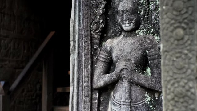 View from toes to head of ancient apsara bas-relief, a female spirit of the clouds and waters in Hindu and Buddhist culture. Bayon temple, Cambodia