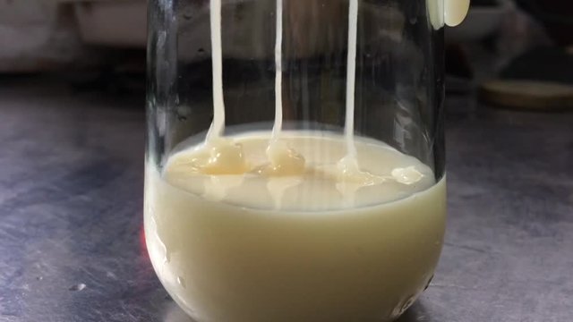 Pour sweetened condensed milk into glass jar.