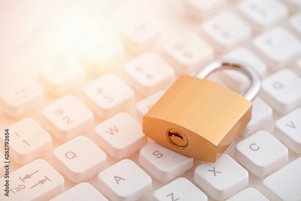 Aufkleber security concept with metal padlock on computer keyboard