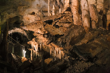 A footbridge allows you to visit the beautiful rock formations of the Antro del Monte Corchia cave in the Apuan Alps in Italy.