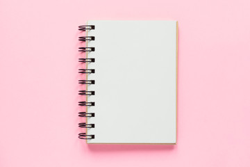 Top view of open empty notebook on pastel pink colorful background