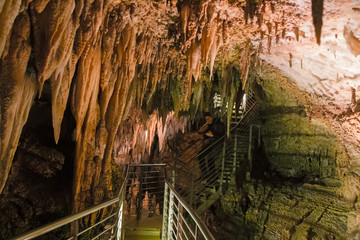 A footbridge allows you to visit the beautiful rock formations of the Antro del Monte Corchia cave in the Apuan Alps in Italy.