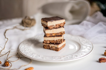 tasty chocolate authentic canadian dessert Nanaimo with nuts in healthy version - plant based and shugar free