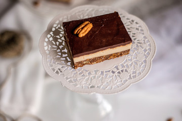 tasty chocolate authentic canadian dessert Nanaimo with nuts in healthy version - plant based and shugar free