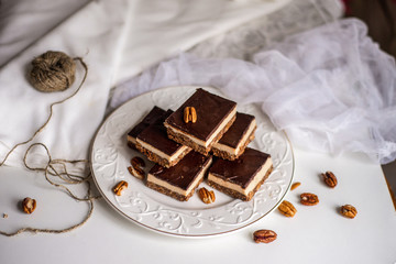 tasty chocolate authentic canadian dessert Nanaimo with nuts in healthy version - plant based and shugar free