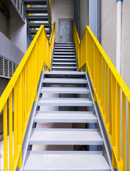 Fototapeta premium Metal fire escape with the yellow ladder.