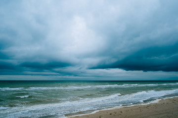 Windy storm beach seashore seaside sea waves dark clouds