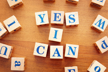 Yes I can. Conceptual image with the text made from wooden cubes on a desk
