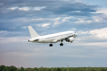 White passenger aircraft in the air on take-off