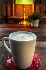Coffee cup in wooden background
