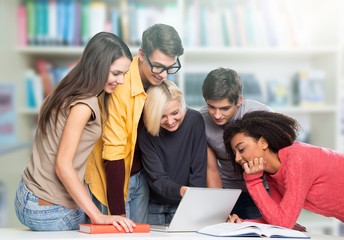 Group of Students with computer at lesson in classroom